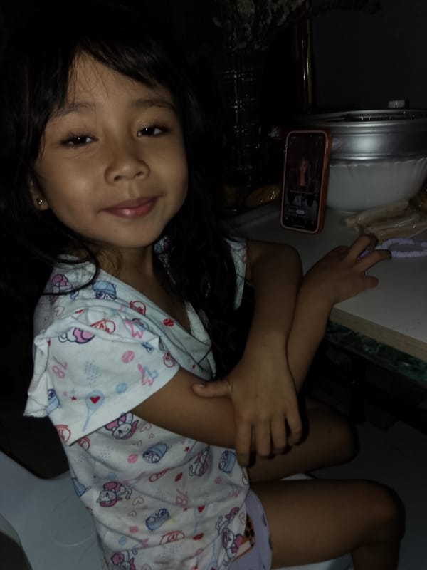 Girl and cats share quiet moments in Davao home