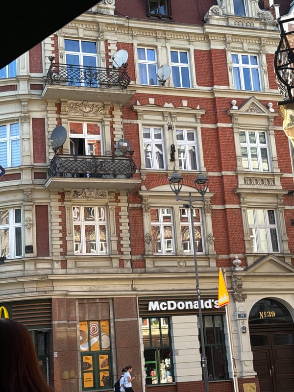 Sunny afternoon cafe scene with iced drinks, historic architecture