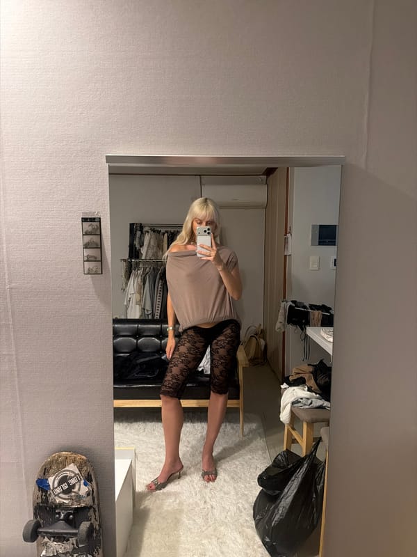 Woman takes mirror selfie in Seoul room