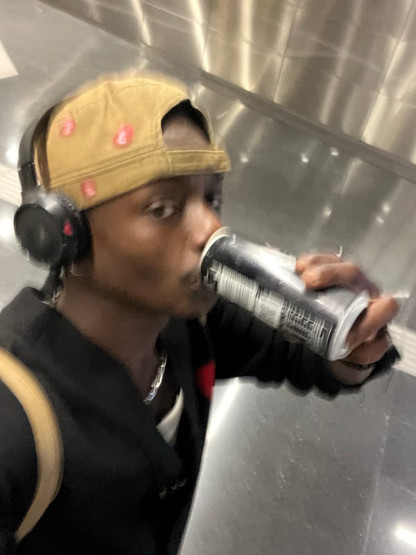 Person photographed drinking from can in Barcelona