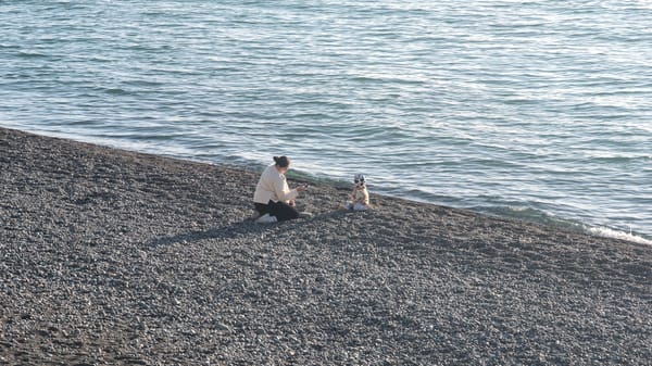 Woman and child spend quiet moment on Kobuleti beach