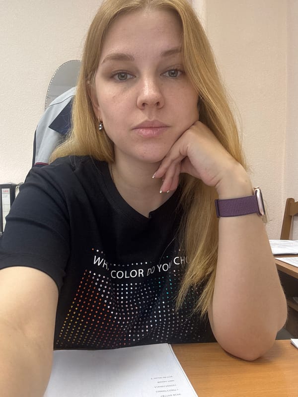 Woman rests in Rusanovo wearing colorful shirt, purple smartwatch