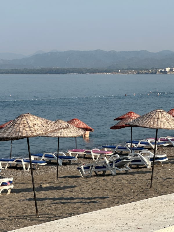 Empty beach chairs on a calm Fethiye morning