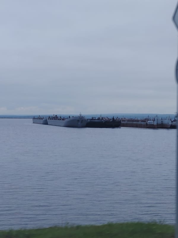 Grey cargo fleet moored on a Russian inland waterway