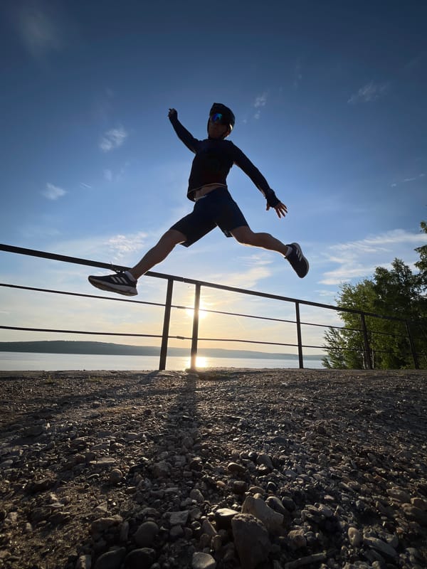 Cyclist performs lakefront stunts at sunset in Chaikovsky, Russia