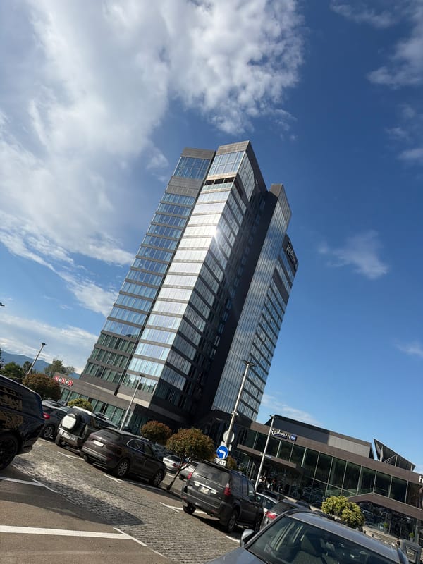 Urban street scene with Radisson hotel observed under clear skies