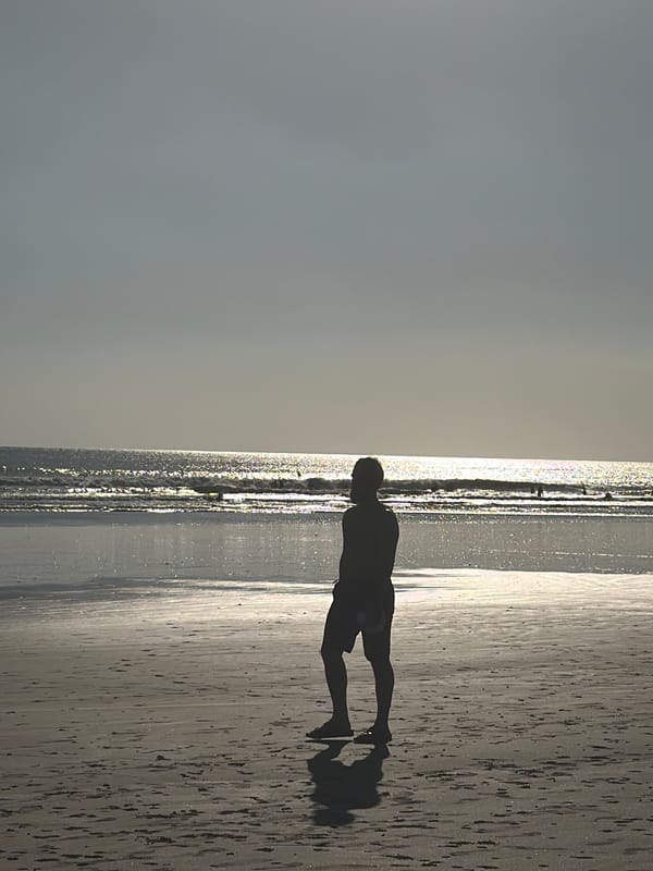 Morning scene at Kuta Beach, Bali — sand, surf, and street life