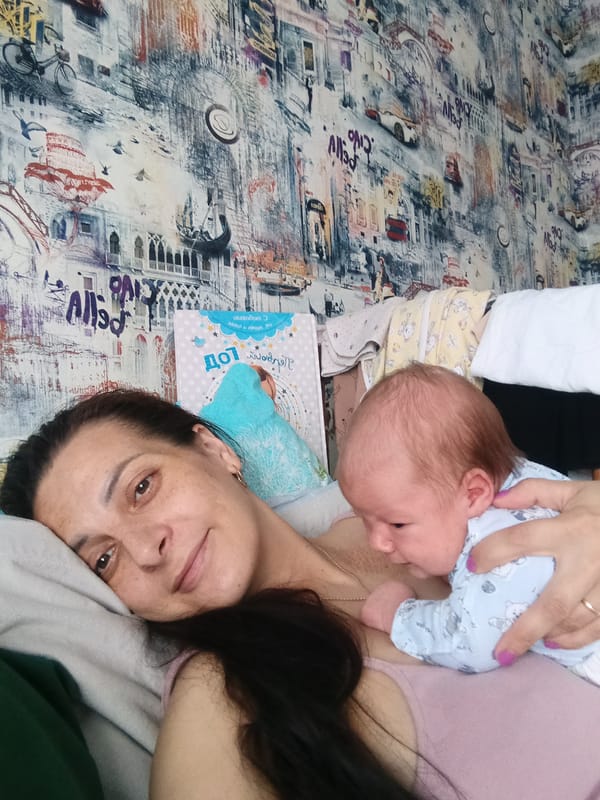 Mother holds baby in quiet moment in Andreyevo