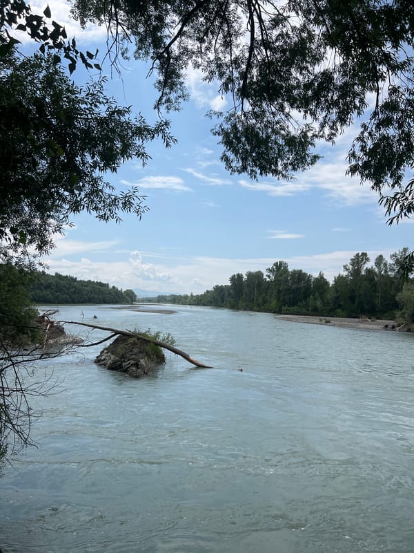 Road trip pause at a wide, glacier-blue river