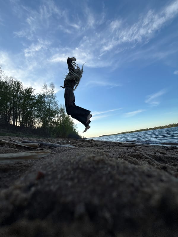 Person performs backflip on beach in Rusanovo, Russia