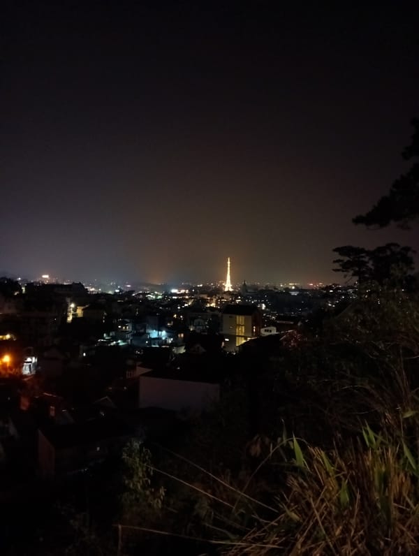 Da Lat's illuminated Eiffel Tower replica captured in nighttime cityscape