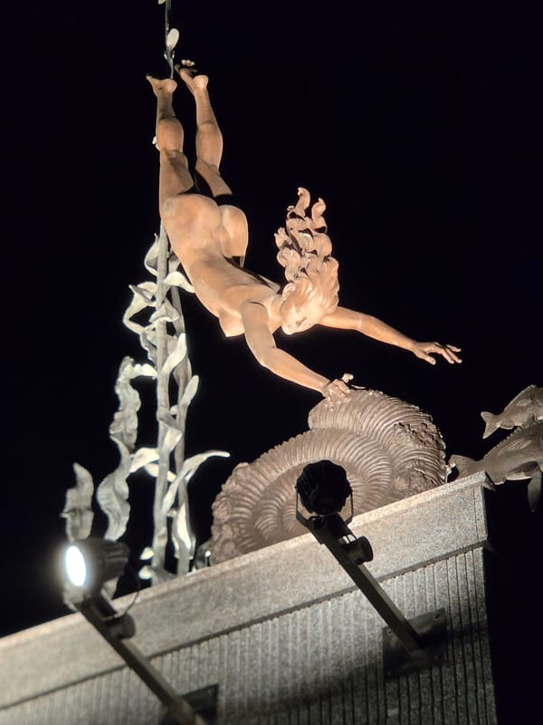 Tolyatti park at night: sculpture, salvia, and lamplit walkway