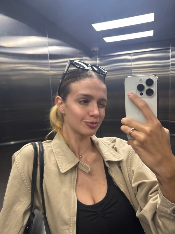 Woman takes elevator selfie with smartphone
