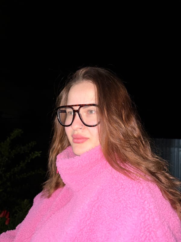 Woman in pink fuzzy sweater spotted at night