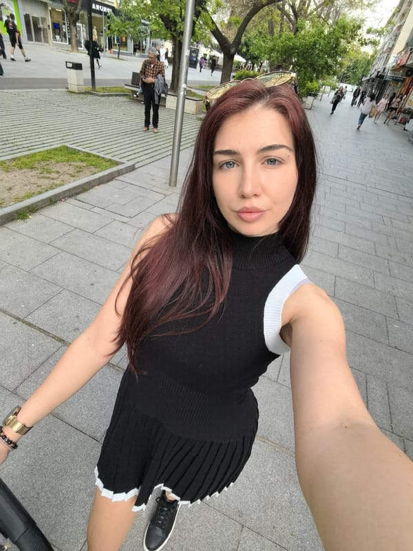 Woman takes selfies among blooming trees in Stara Zagora