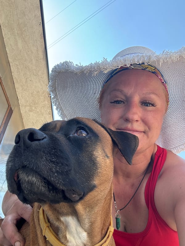 Woman poses for outdoor photos with dog in hat