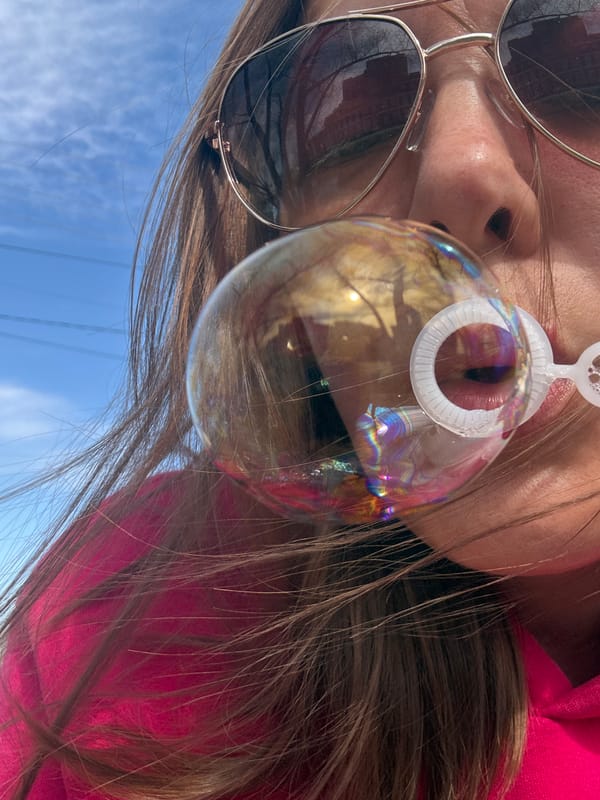 Person blows bubbles outdoors in Dmitrov, Russia morning scene