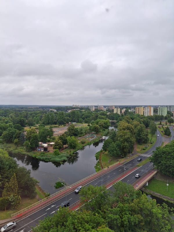 Aerial view of Piła's urban landscape, greenery, and waterway