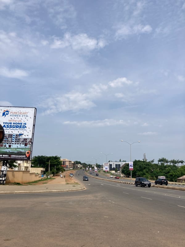 Morning traffic infrastructure observed in Abuja under partly cloudy skies