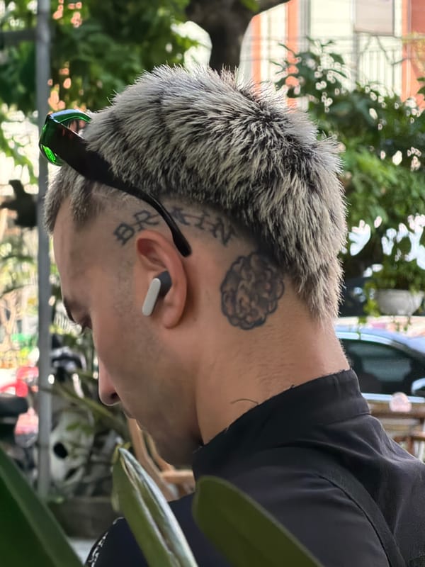Morning scenes captured at Đà Nẵng cafe with tattooed patron