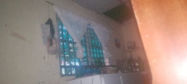 Interior scene captured with grated window and wall poster