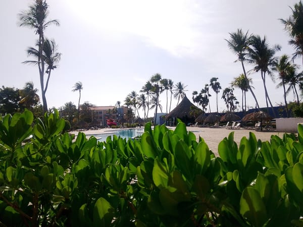 Tourist documents resort scenes at Playa El Agua, Venezuela