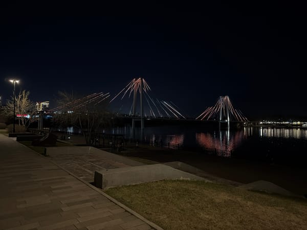 Illuminated bridges reflect on Yenisei River in Krasnoyarsk night
