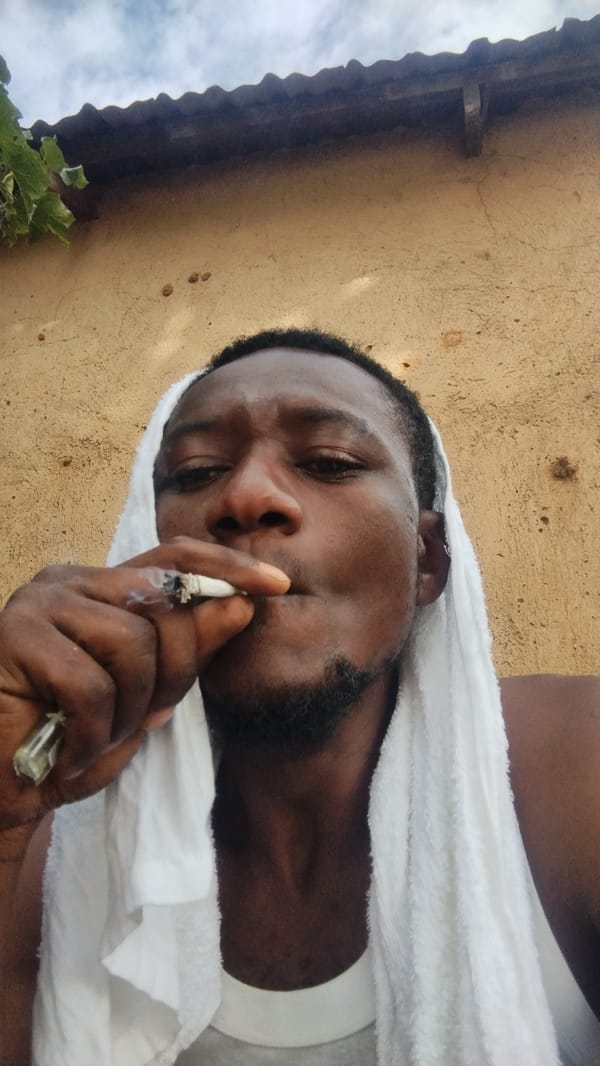 Casual outdoor selfie session in Jos, towel and cigarette in hand