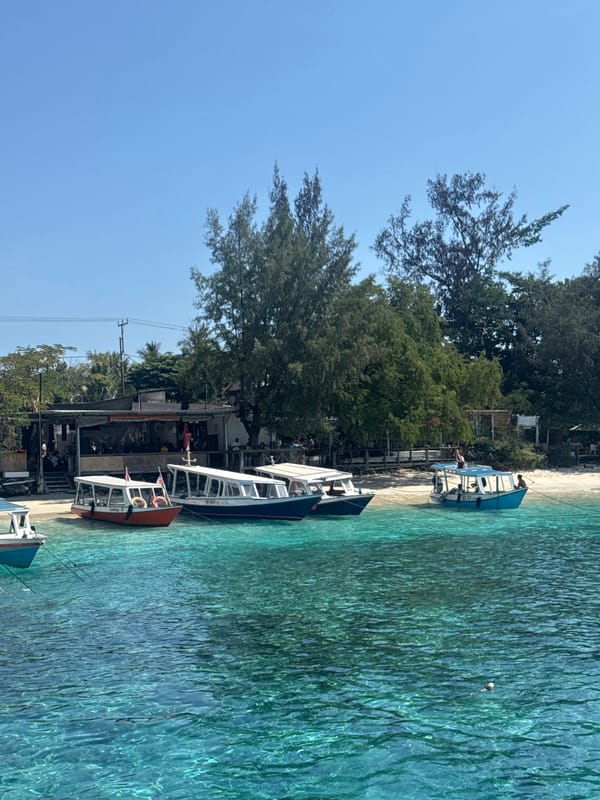 Boats and clear water at a sunny Indonesian harbor