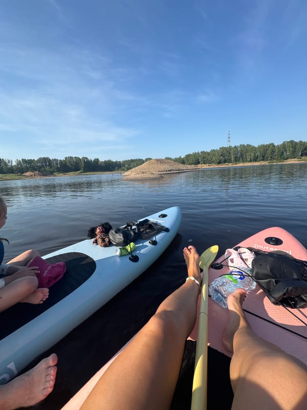 Paddleboarding spot on calm Russian lake with sandy dunes