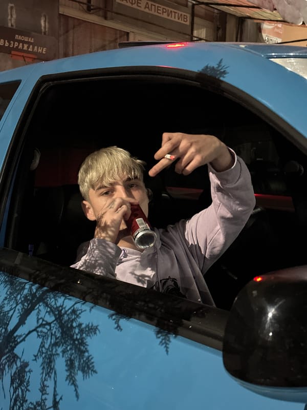 Person smoking, drinking in parked blue car in Velingrad