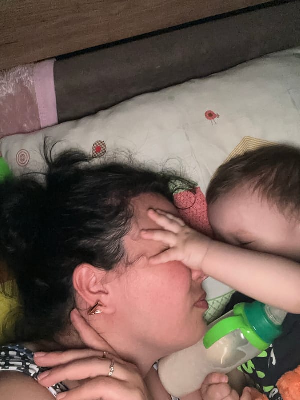 Baby plays on a quilt, quiet indoor moments together