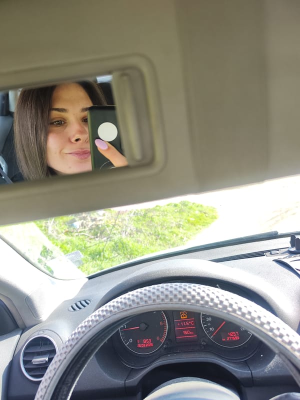 Woman takes selfie while driving through Bulgarian countryside