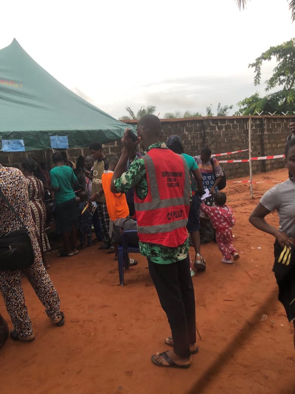 Community gathering under tent in Nteje, Nigeria