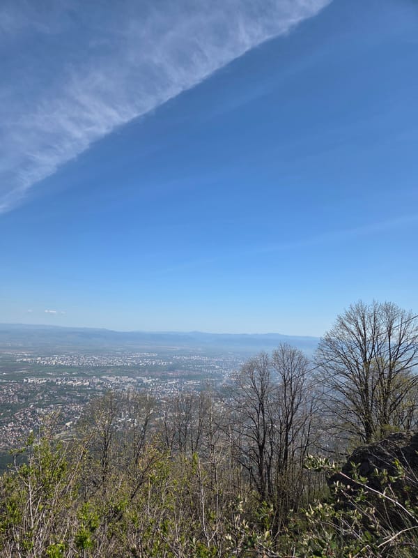 Young hikers photographed on elevated terrain overlooking Sofia