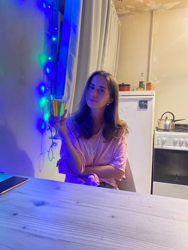 Evening drinks at a Perm table under colorful string lights