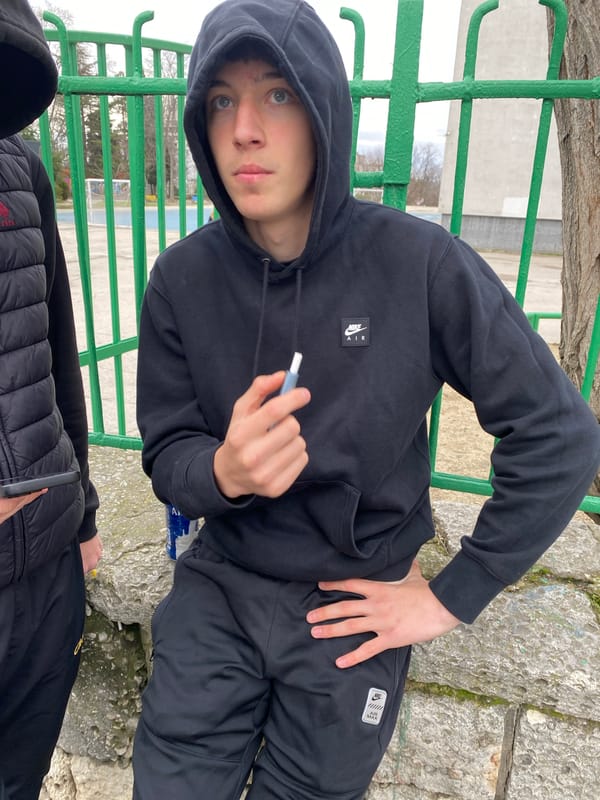 Young men pose for photos near railing in Varna