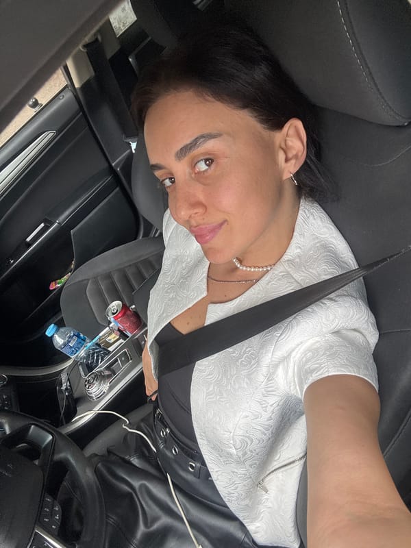 Woman poses for car selfies during Tbilisi street photography session