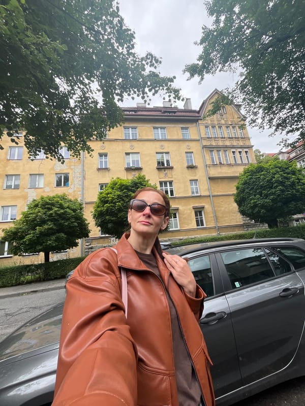 Woman in Brown Jacket Takes Selfies Across City
