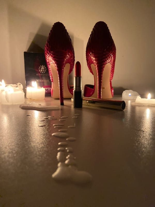 Red stilettos and makeup arranged in styled display