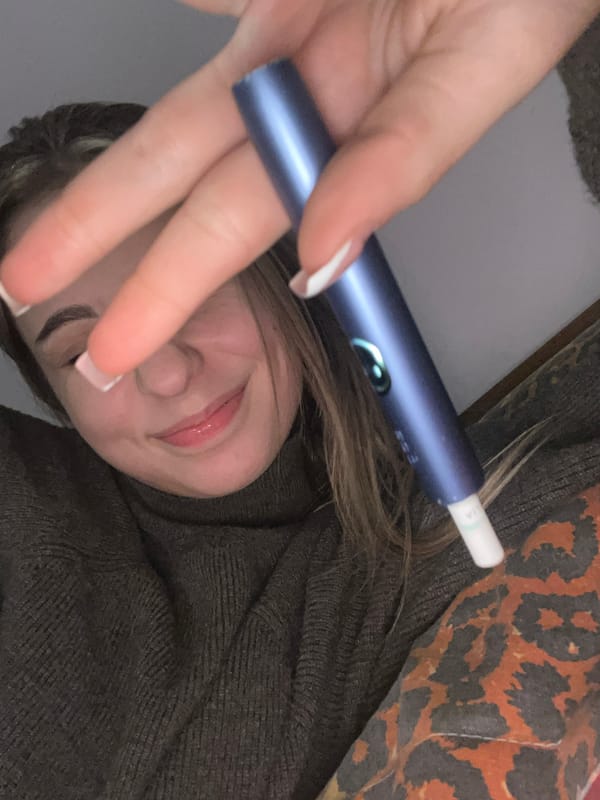 Person resting with electronic device in Varna bedroom