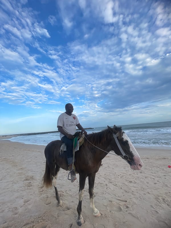 Horseback riders and vendors enjoy afternoon at Nigerian beaches