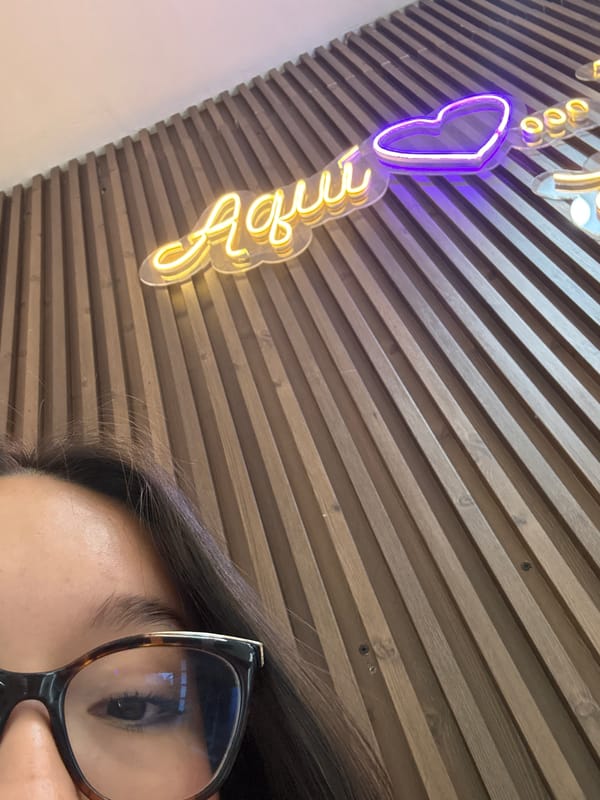 Person photographed with neon heart sign in Acapulco