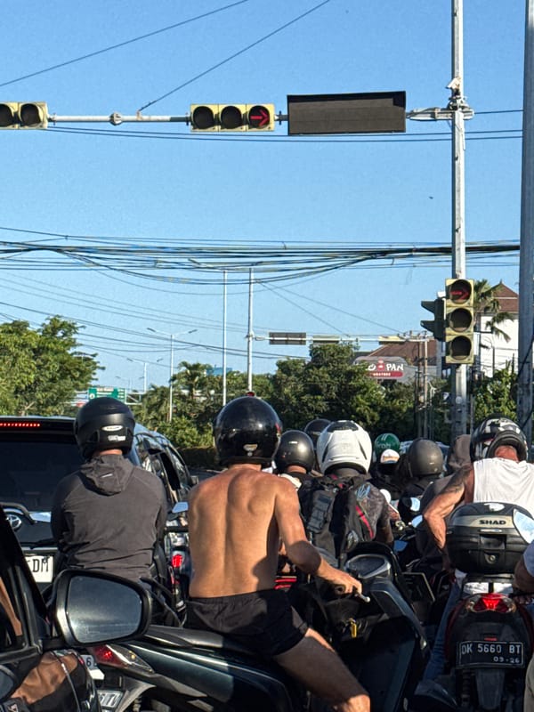 Motorcyclists stop at red light in Denpasar traffic