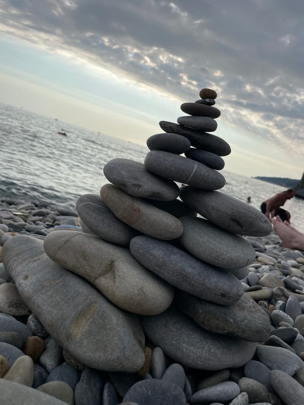 Stone stacking and stormy skies on the Sochi shoreline