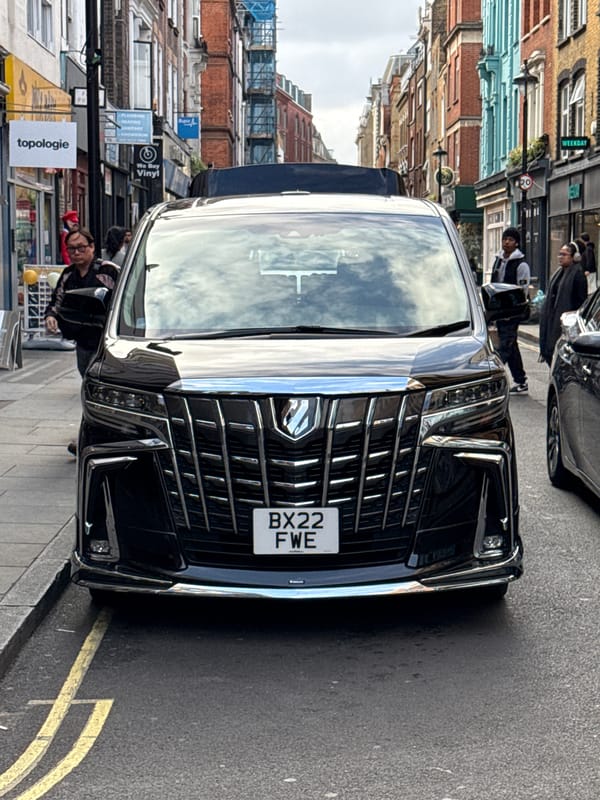 Black car parked on double yellow lines in London