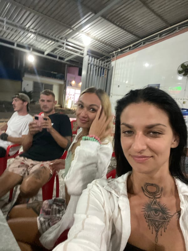Friends share BBQ frog dinner at Vietnam street restaurant