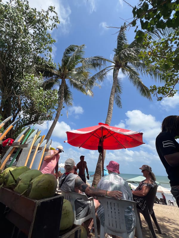 Lazy morning at Kuta Beach — vendors, umbrellas, and ocean views