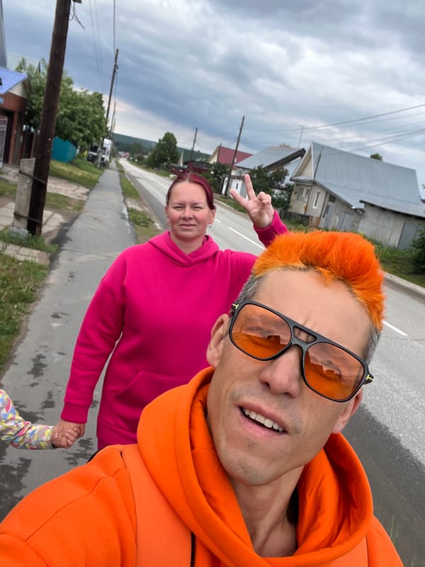 Family in orange outfits plays in puddles in Chaikovsky