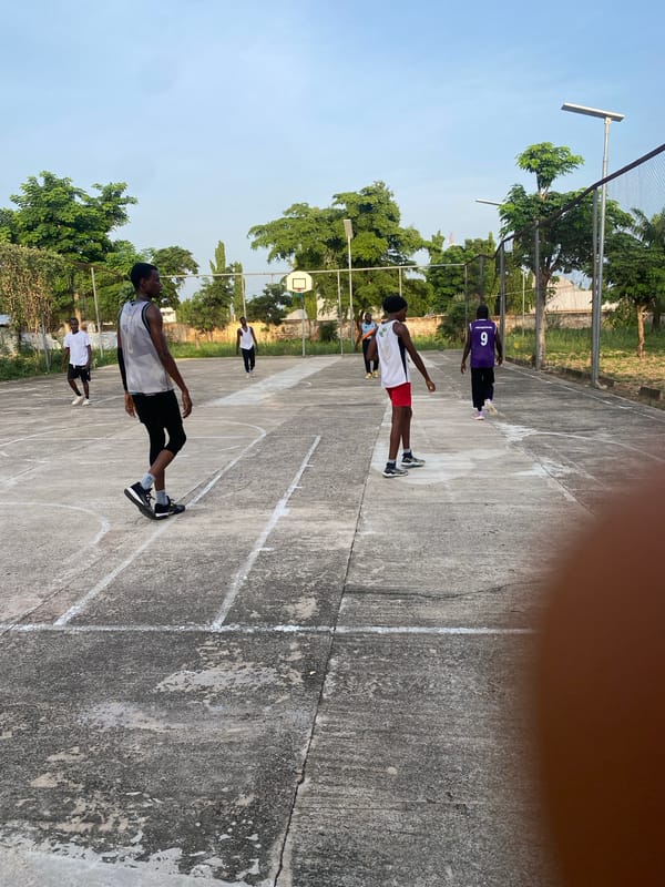 Outdoor basketball session on a concrete court in Jalingo, Nigeria